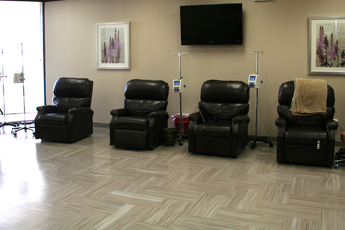 Modern clinic room with comfortable seats for patients receiving treatment in Houston, TX